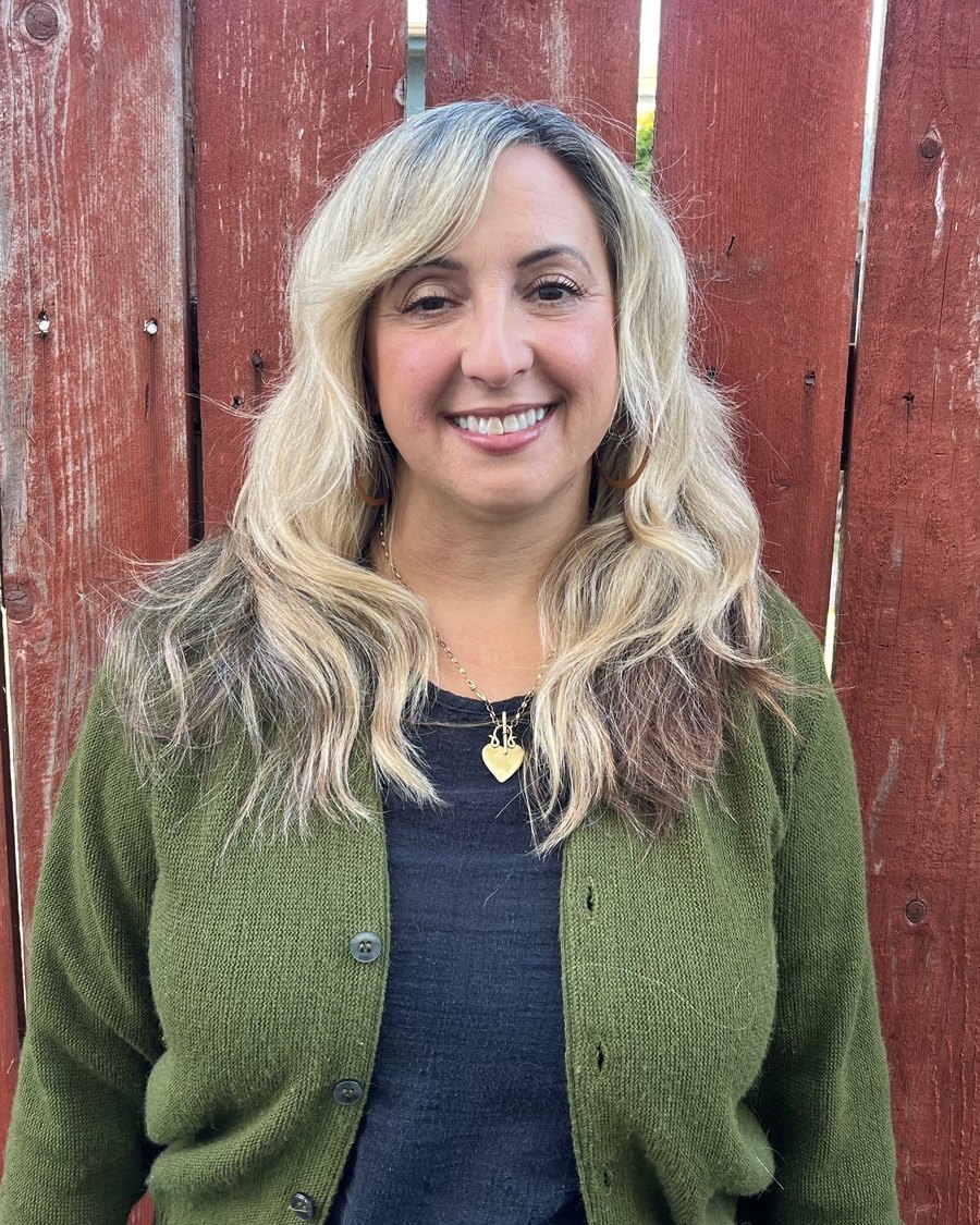 Mindi Marcus, LMFT, smiling, in a green cardigan